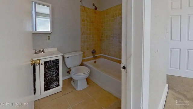 a white toilet sitting next to a bathroom sink