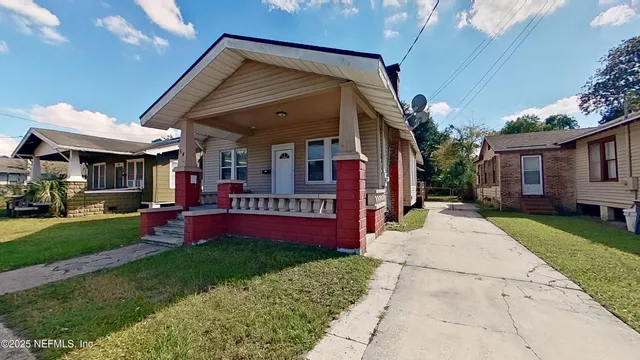 a view of a house with a yard porch and sitting area