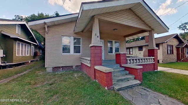 a front view of house with yard and outdoor seating