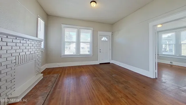 wooden floor in an empty room with a window