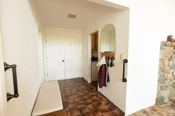 a bathroom with a walk in closet and mirror