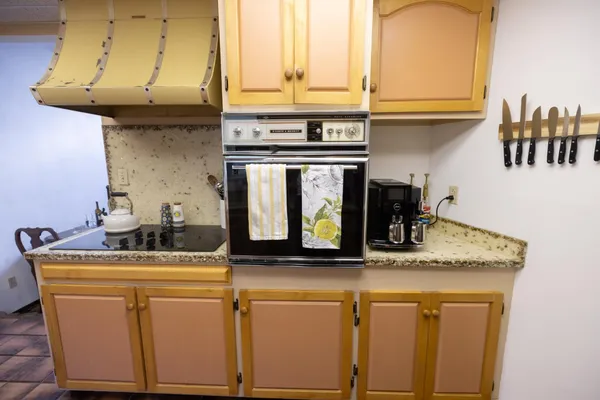 a kitchen with granite countertop a sink and cabinets