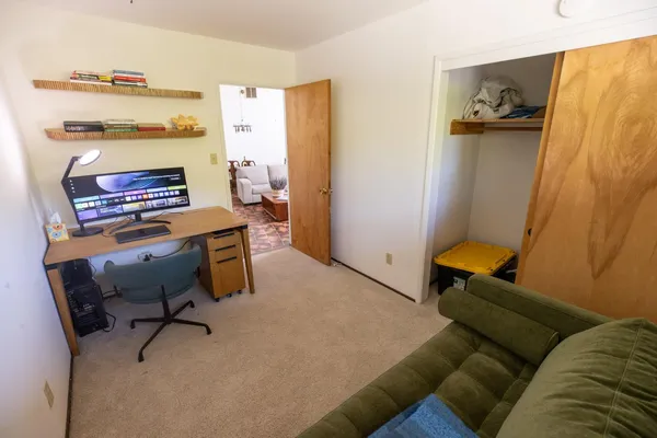 a spacious bedroom with a bed and a window