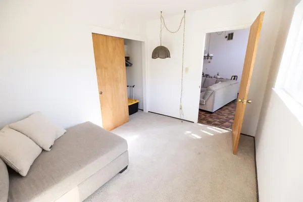 a bedroom with a bed and a window