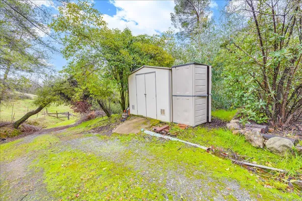 a view of a backyard with table and chairs and wooden fence