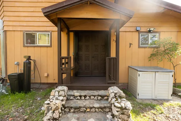 a front view of a house with a garden