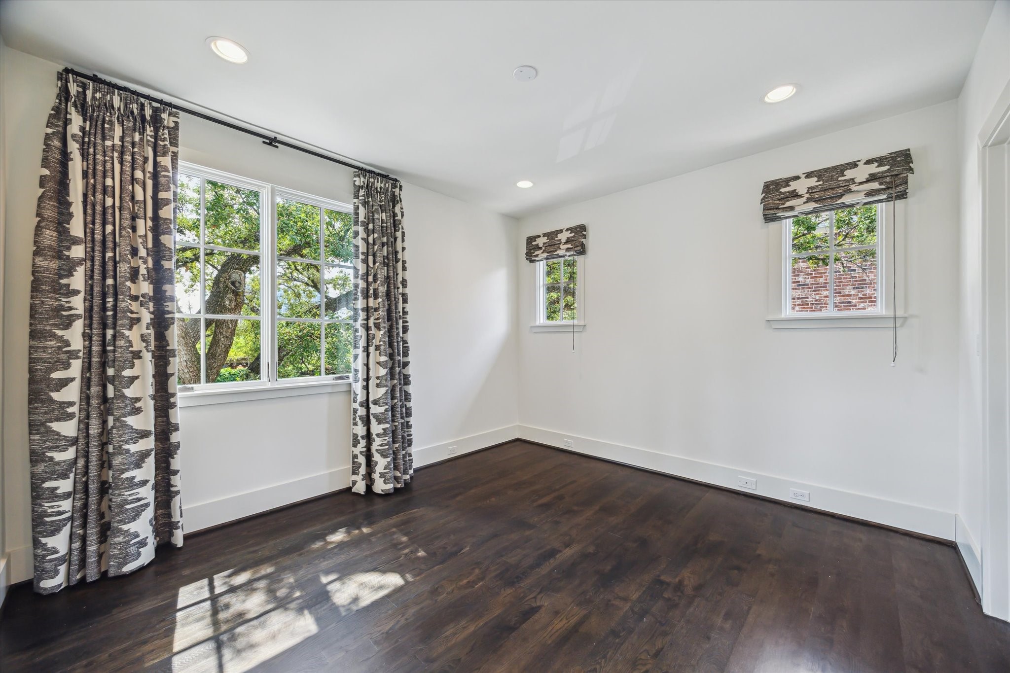 3214 Westheimer Road Houston, TX 77098 - Photo 24 of 34 a view of an empty room with a window and wooden floor