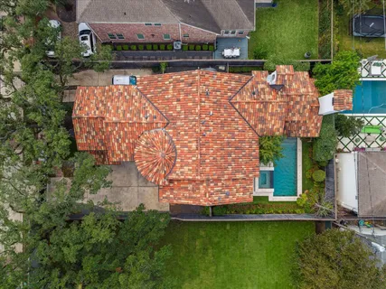 an aerial view of house with yard swimming pool and outdoor seating