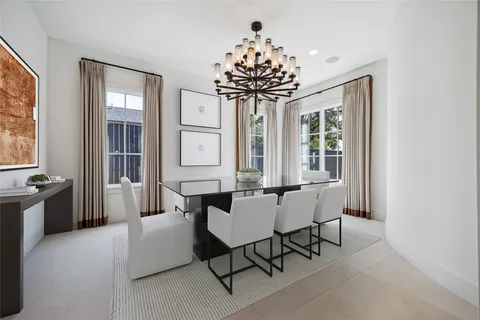 a dining room with furniture a chandelier and window