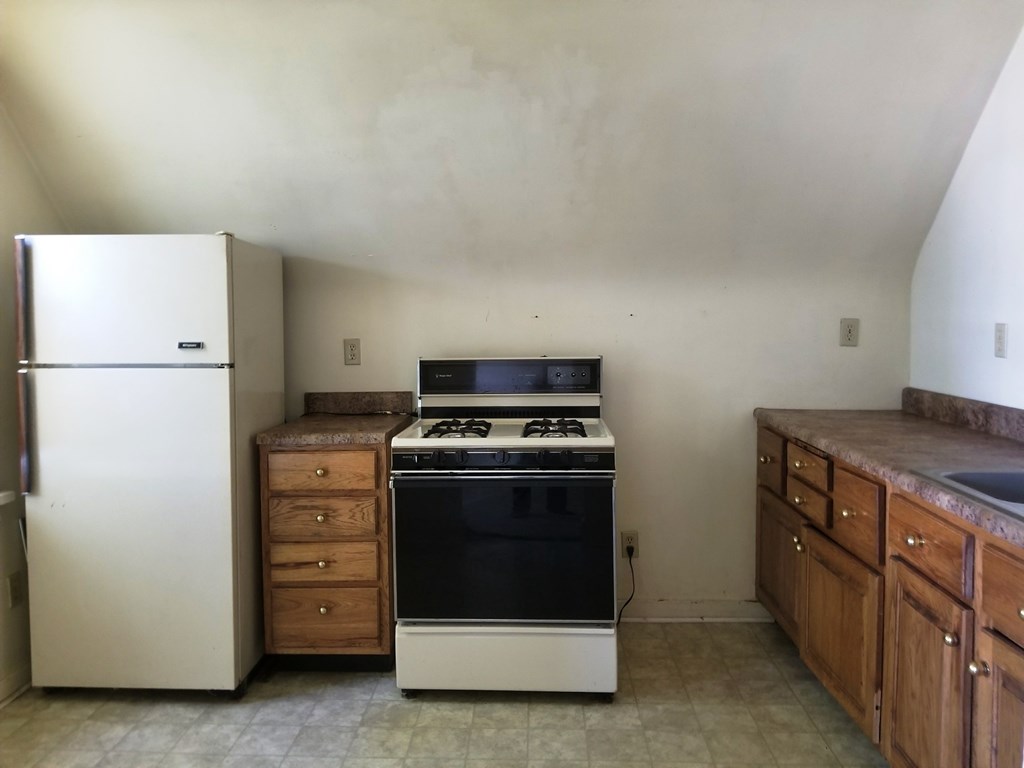 410 Main Street Strattanville, PA 16258 - Photo 2 of 7 a kitchen with a stove and a refrigerator