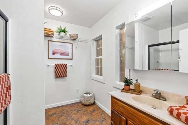 a bathroom with a sink mirror and vanity