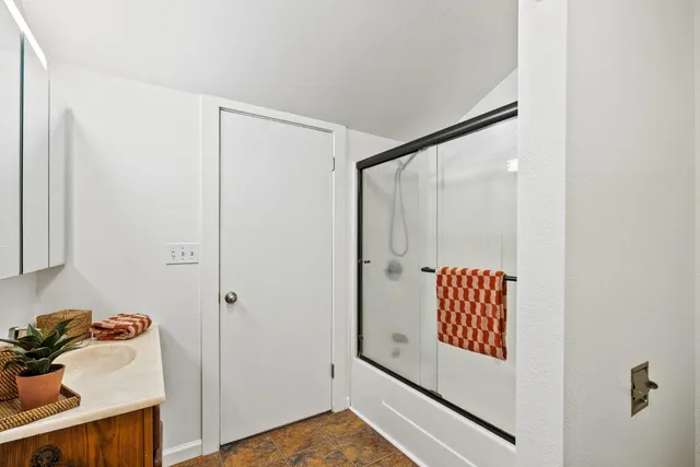 a bathroom with a shower and a sink