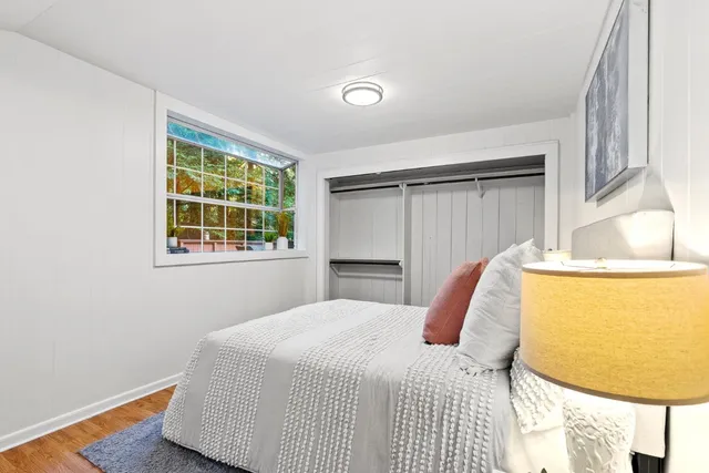 a bedroom with a bed and a window