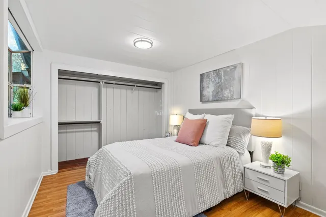 a bedroom with a bed and a potted plant
