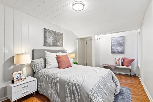 a bedroom with a bed and a couch