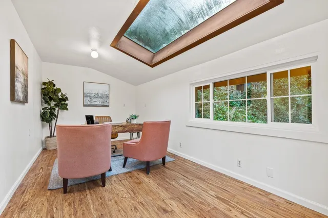 a workspace room with furniture and a window