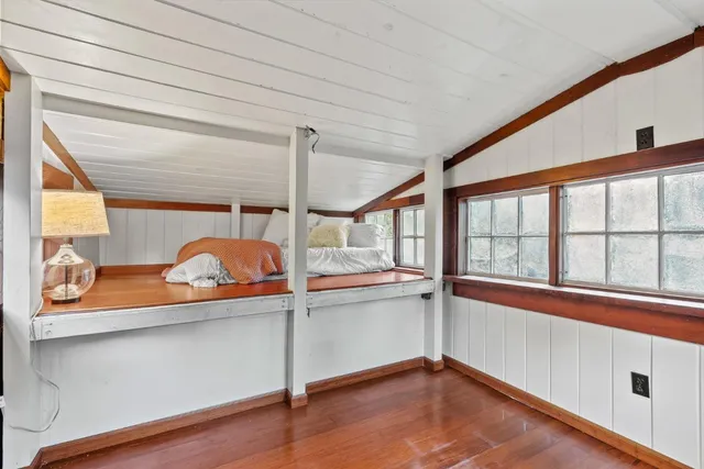 a view of a room with wooden floor and fan