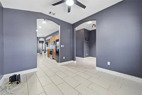 a view of a hallway with closet and a chandelier fan