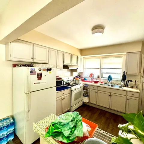 a kitchen with sink cabinets and stainless steel appliances