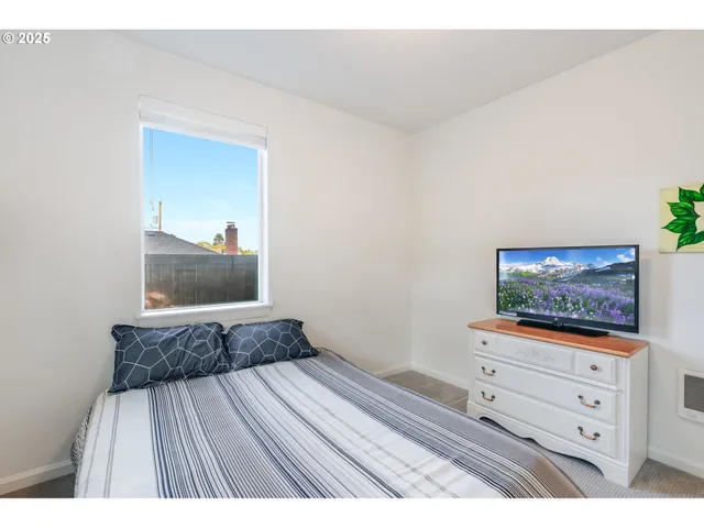 a bathroom with a sink a toilet a mirror and shower