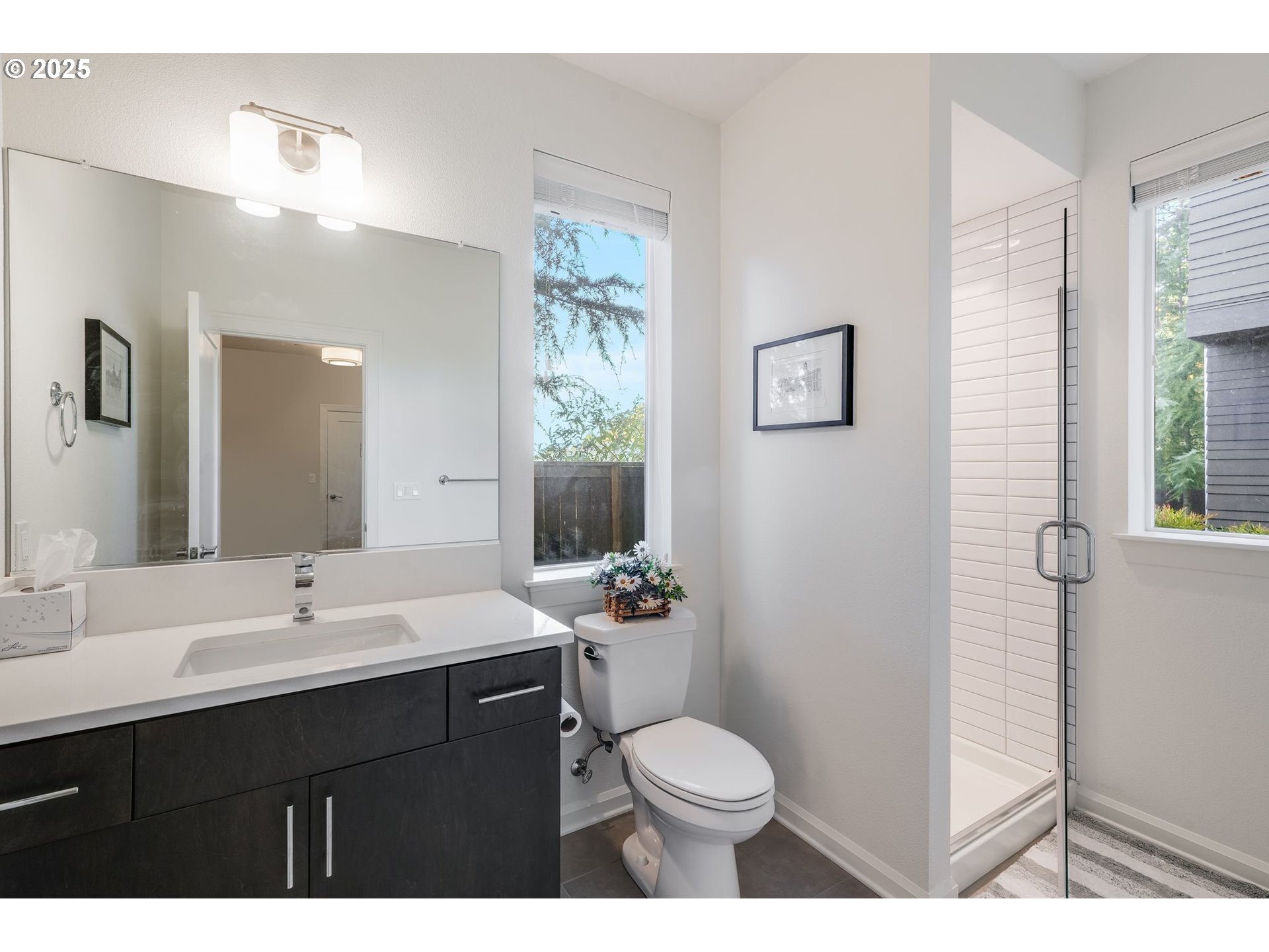 77 Northeast 58th Avenue Portland, OR 97213 - Photo 12 of 36 a bathroom with a sink a toilet a mirror and shower