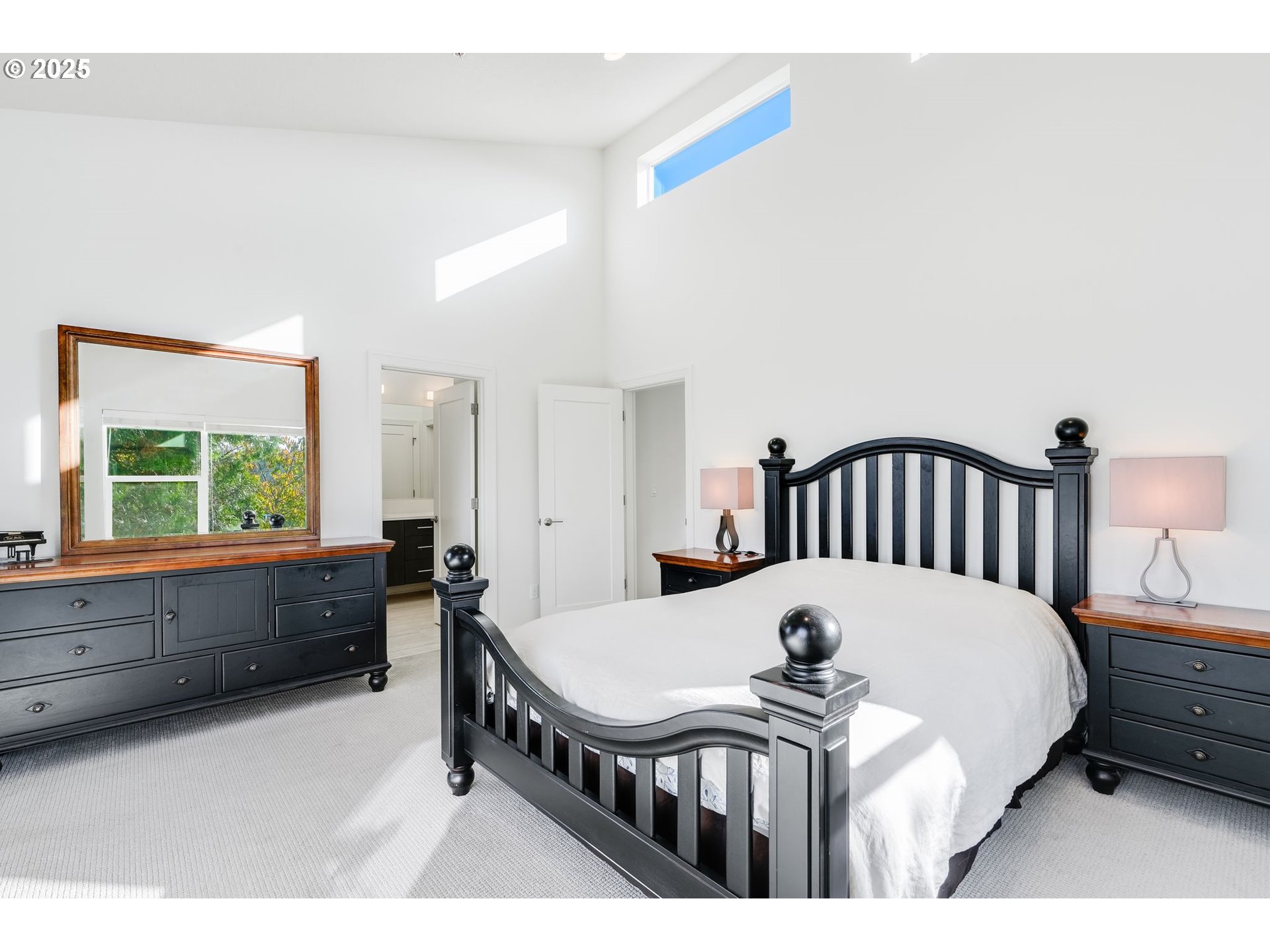 77 Northeast 58th Avenue Portland, OR 97213 - Photo 17 of 36 a bedroom with a bed a dresser and large window