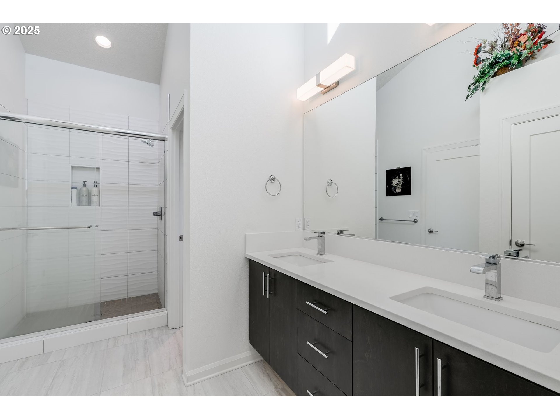 77 Northeast 58th Avenue Portland, OR 97213 - Photo 22 of 36 a bathroom with a double vanity sink a large mirror and shower