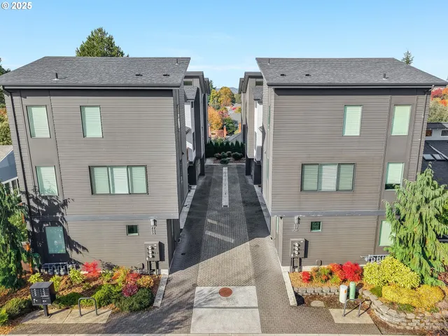 an aerial view of a house with yard and parking