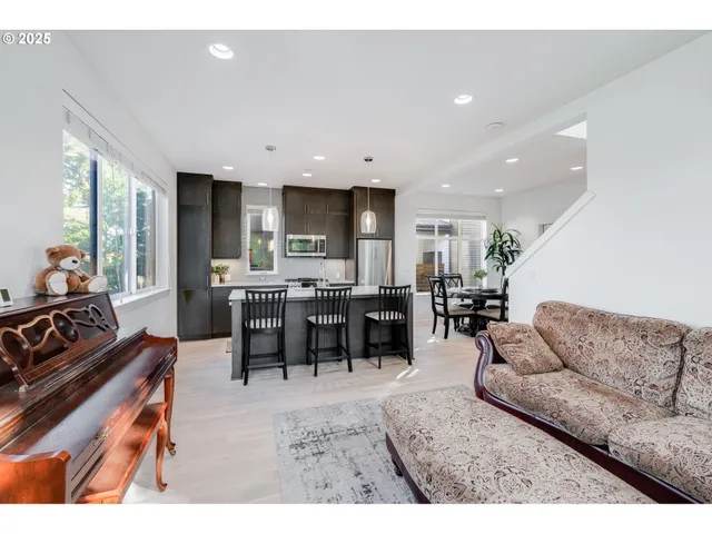 a dining room with furniture and a kitchen view