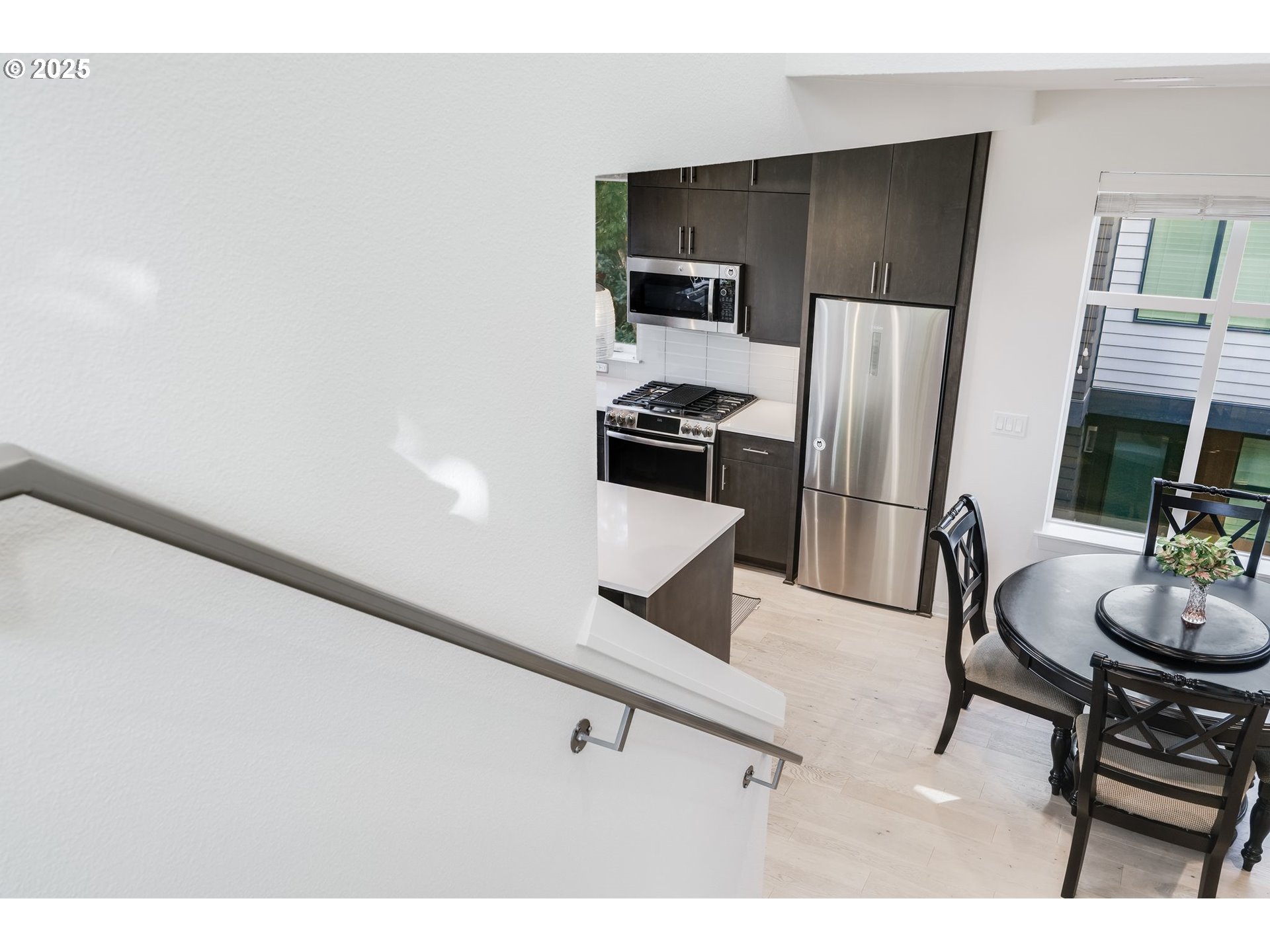 77 Northeast 58th Avenue Portland, OR 97213 - Photo 8 of 36 a kitchen with stainless steel appliances kitchen island granite countertop a refrigerator a stove a sink and dishwasher