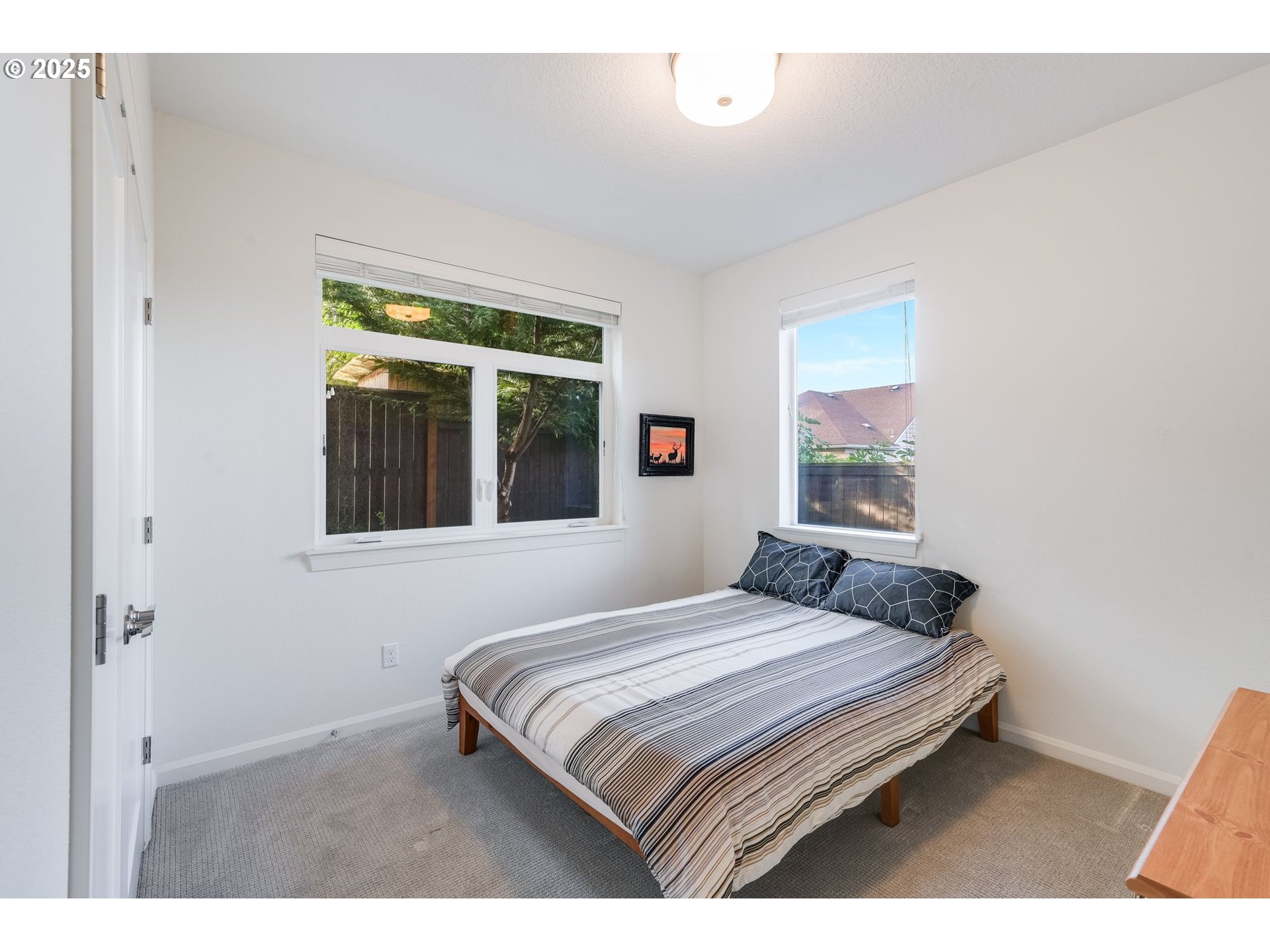 77 Northeast 58th Avenue Portland, OR 97213 - Photo 9 of 36 a bedroom with a bed and a large window