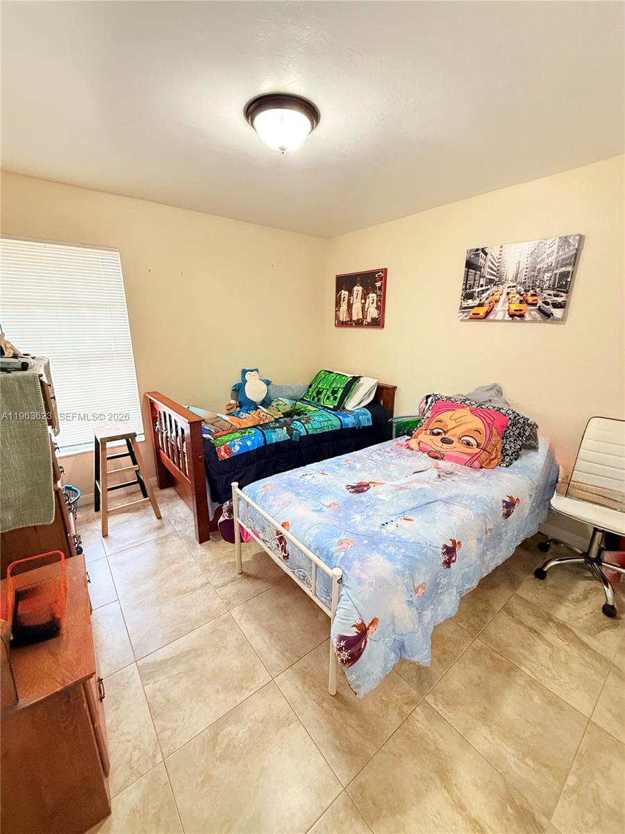 755 Arundel Circle Fort Myers, FL 33913 - Photo 15 of 22 a bedroom with a bed and a table in it