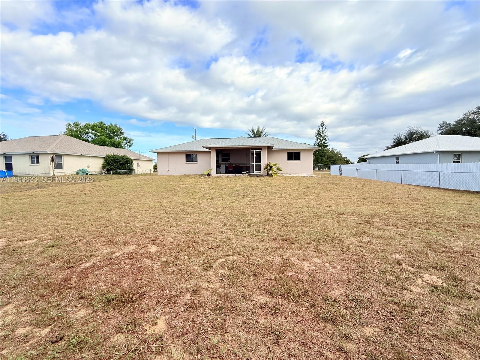 755 Arundel Circle Fort Myers, FL 33913 - Photo 22 of 22 a view of a house with a big yard and a large tree