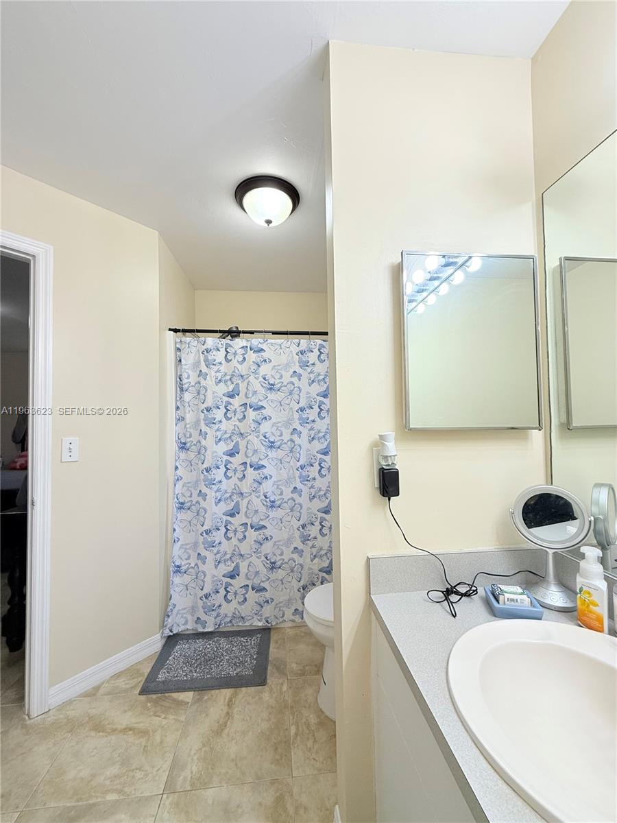 755 Arundel Circle Fort Myers, FL 33913 - Photo 10 of 22 a bathroom with a granite countertop sink a mirror and shower