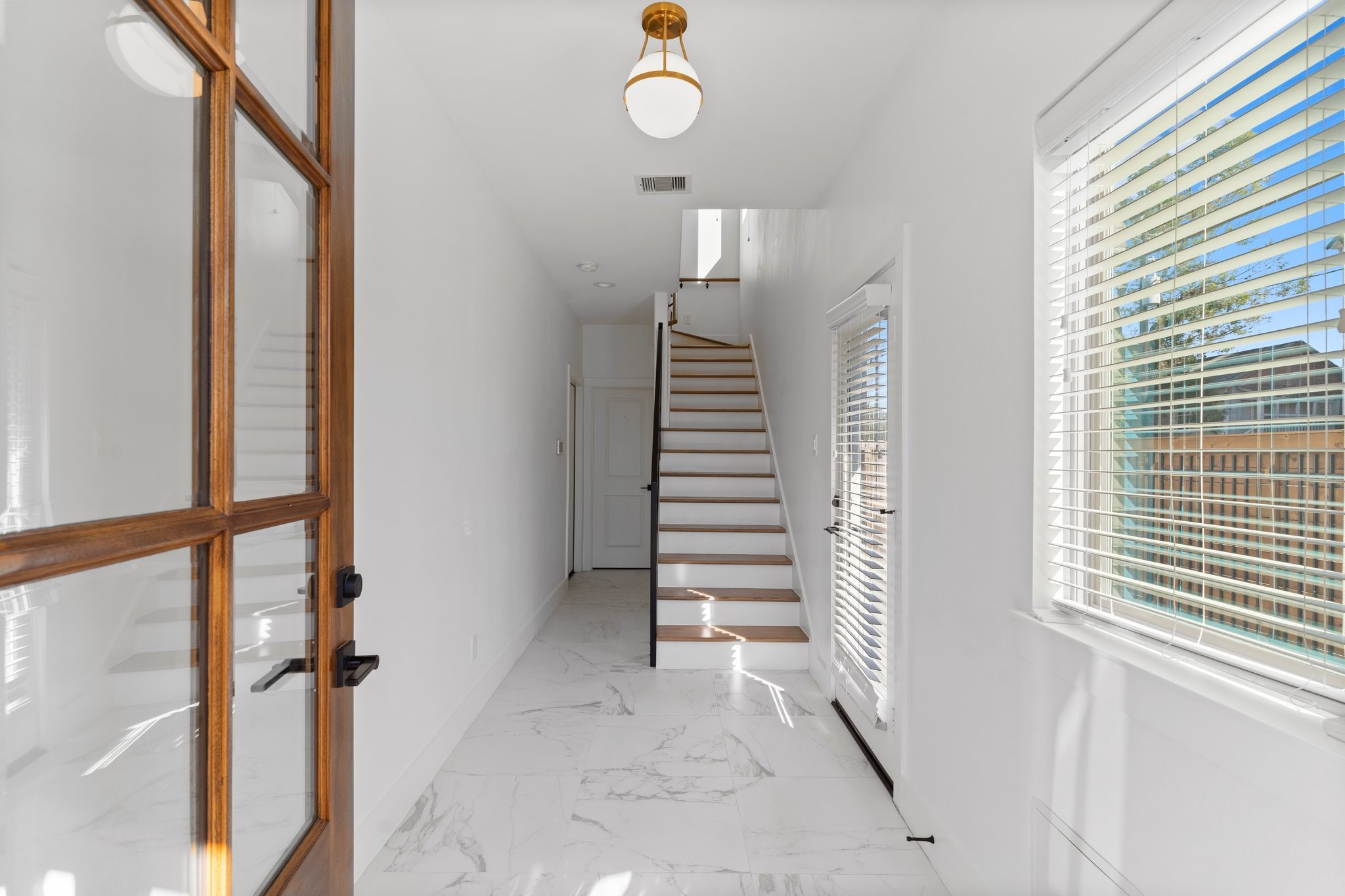 1602 Chestnut Street Houston, TX 77009 - Photo 11 of 49 a view of entryway with stairs and wooden floor
