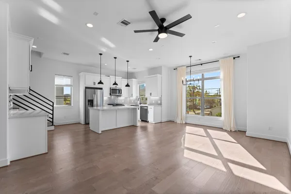 a large kitchen with stainless steel appliances kitchen island a stove a sink dishwasher a oven with white cabinets