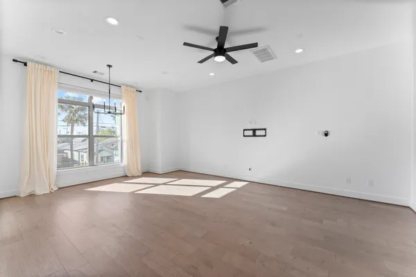 a open kitchen with stainless steel appliances granite countertop a refrigerator a sink dishwasher a stove and white countertops with wooden floor