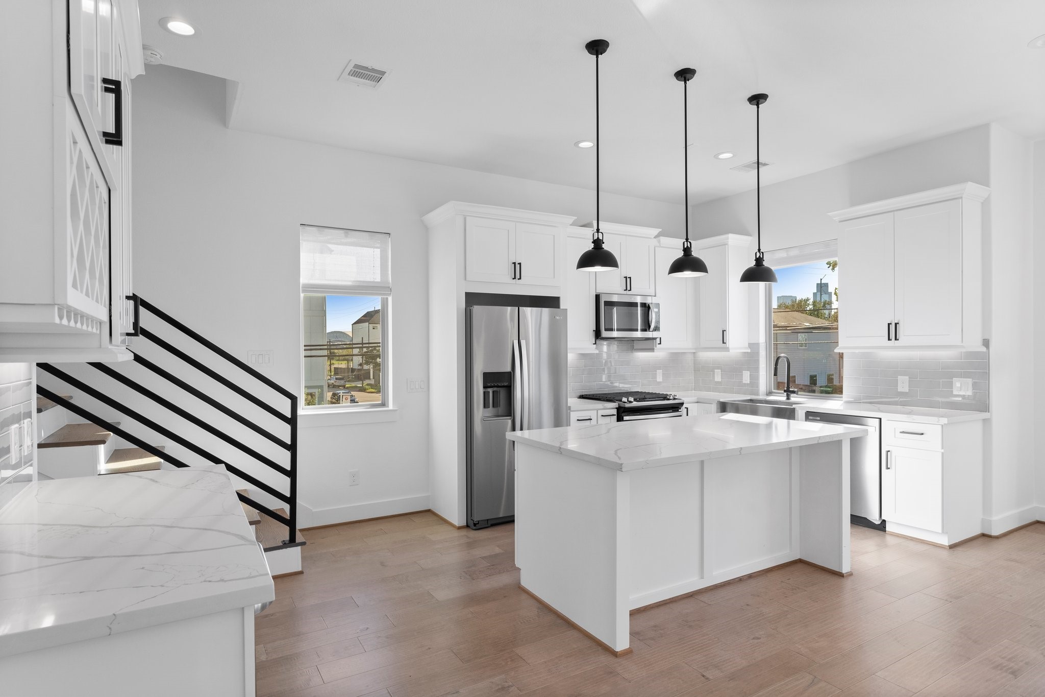 1602 Chestnut Street Houston, TX 77009 - Photo 16 of 49 a kitchen with stainless steel appliances kitchen island granite countertop a stove a sink and white cabinets