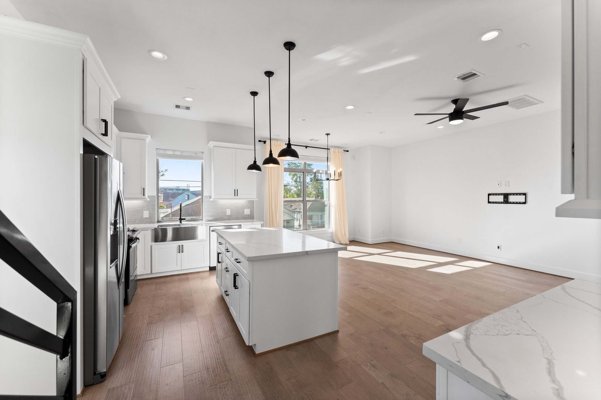 1602 Chestnut Street Houston, TX 77009 - Photo 17 of 49 a open kitchen with stainless steel appliances granite countertop a refrigerator a sink dishwasher a stove and white countertops with wooden floor