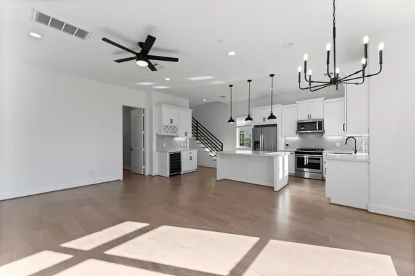 an empty room that has a window and a ceiling fan