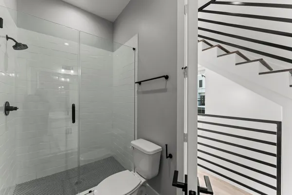 a view of a livingroom with a ceiling fan & entryway