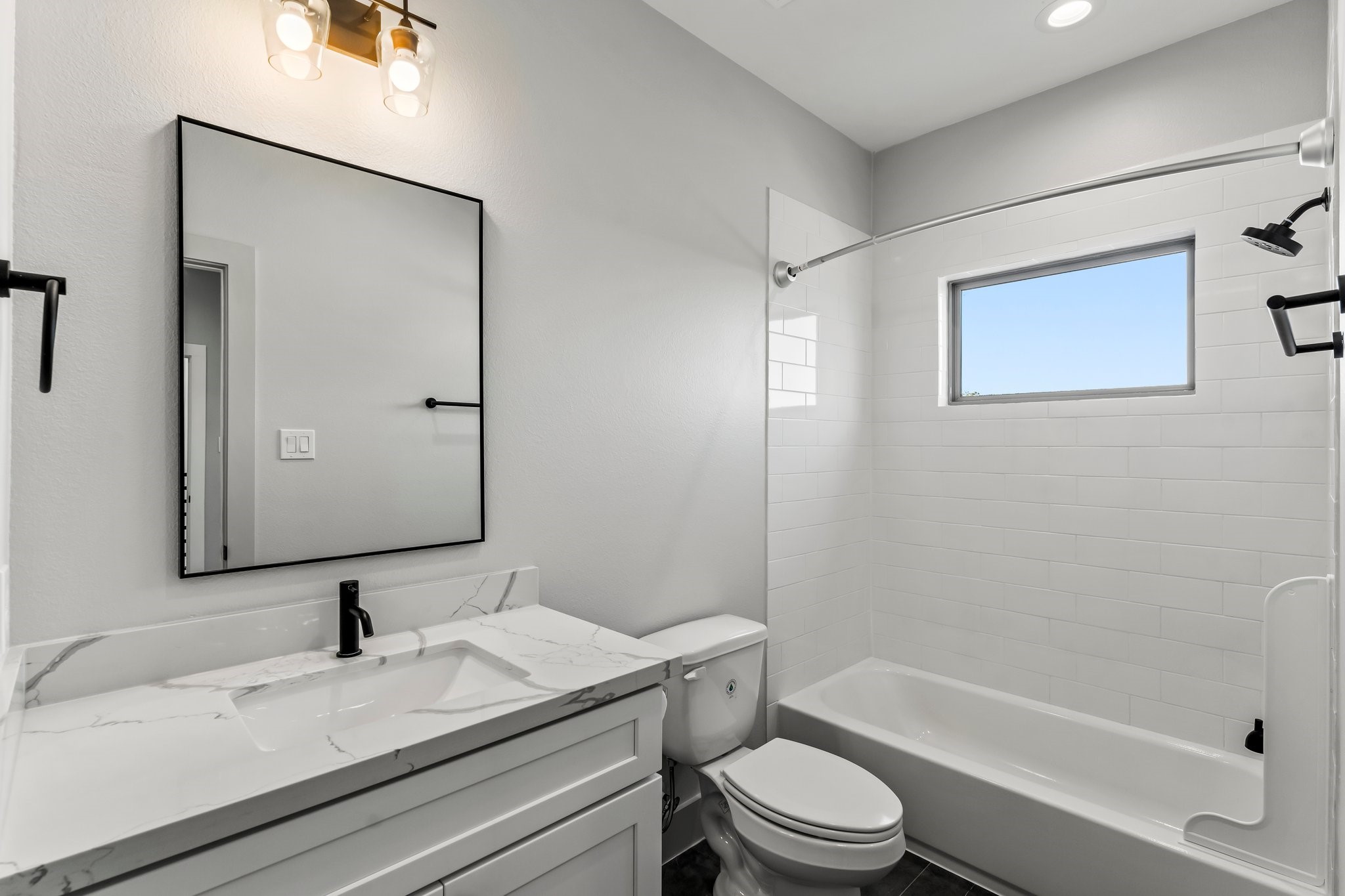 1602 Chestnut Street Houston, TX 77009 - Photo 29 of 49 a bathroom with a granite countertop toilet sink and mirror