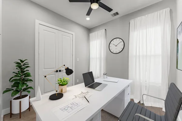 a living room with furniture kitchen view and a flat screen tv