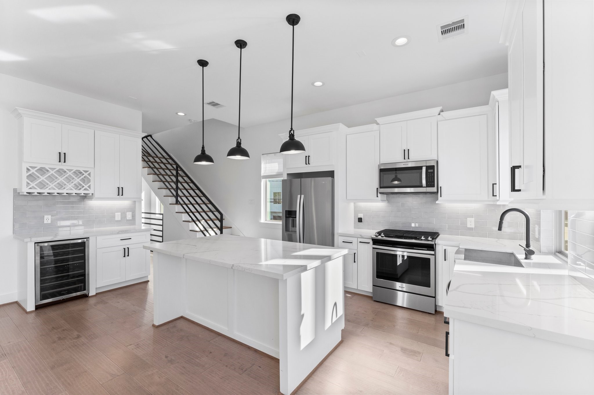 1602 Chestnut Street Houston, TX 77009 - Photo 6 of 49 a kitchen with stainless steel appliances kitchen island a stove a sink and a refrigerator