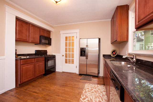 306 Read Street Elburn, IL 60119 - Photo 2 of 18 a kitchen with stainless steel appliances granite countertop a stove a sink and a refrigerator