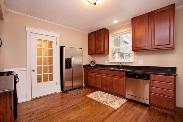 306 Read Street Elburn, IL 60119 - Photo 3 of 18 a kitchen with stainless steel appliances granite countertop wooden cabinets a refrigerator and a sink