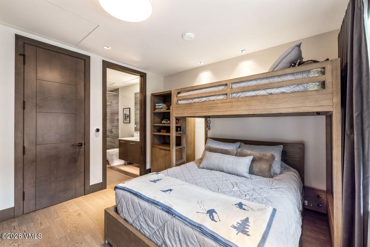 430 South Frontage Road East, Unit RU303 Vail, CO 81657 - Photo 14 of 39 a bedroom with a bed and a mirror