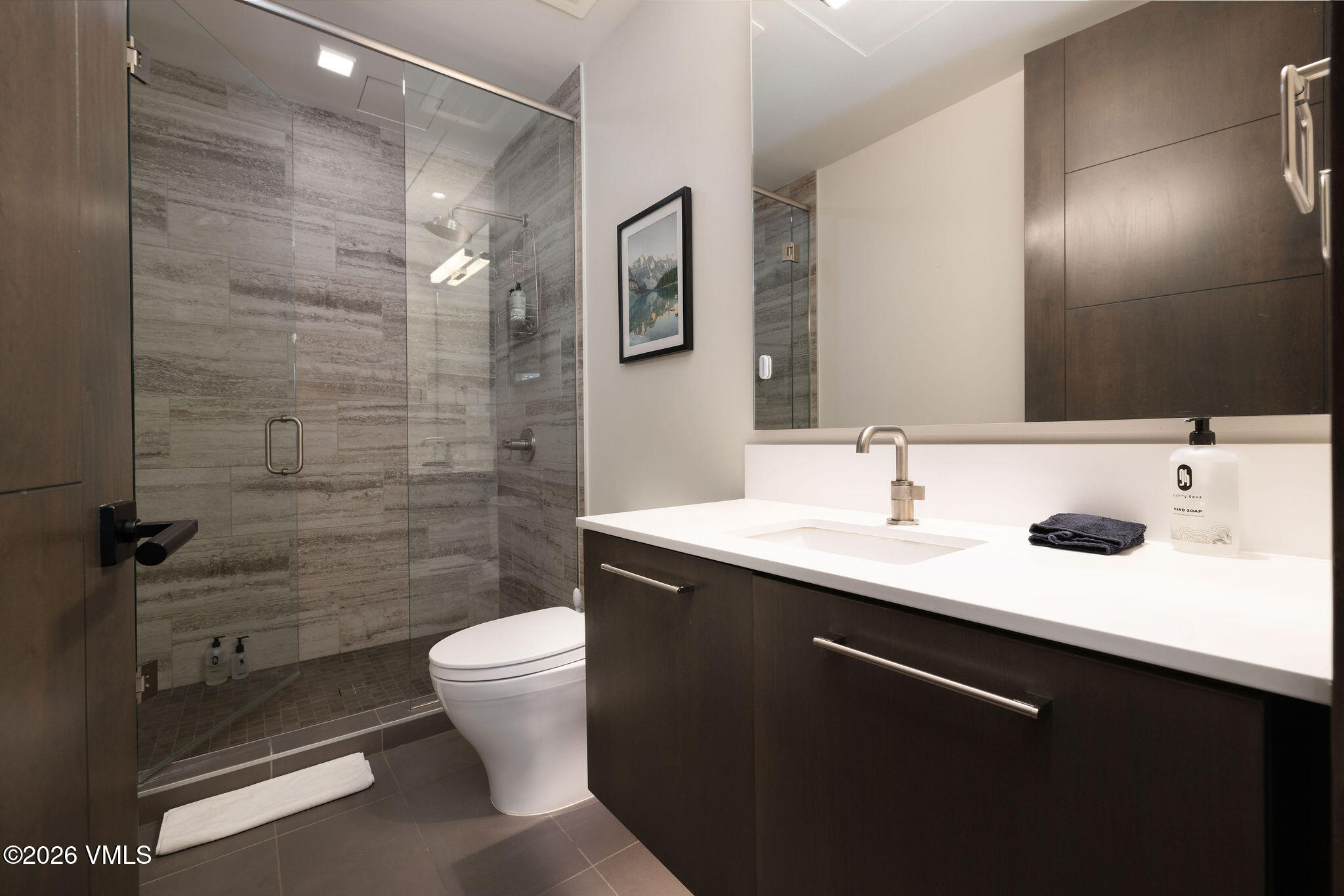 430 South Frontage Road East, Unit RU303 Vail, CO 81657 - Photo 15 of 39 a bathroom with a sink a toilet a mirror and shower