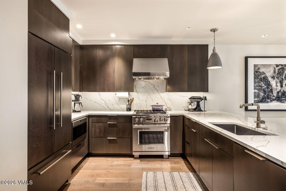 430 South Frontage Road East, Unit RU303 Vail, CO 81657 - Photo 5 of 39 a kitchen with stainless steel appliances granite countertop a sink and a stove