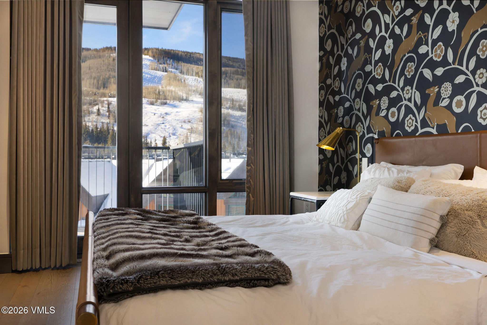 430 South Frontage Road East, Unit RU303 Vail, CO 81657 - Photo 7 of 39 a bedroom with a large bed and a large window with outer view